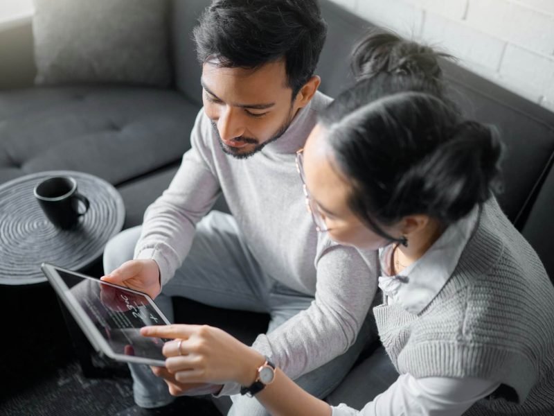 tablet-sofa-and-couple-with-smart-home-technology-for-thermostat-heating-apartment-security-netwo.jpg